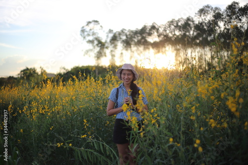 A woman standing in the crotalaria juncea field in Rayong, Thailand