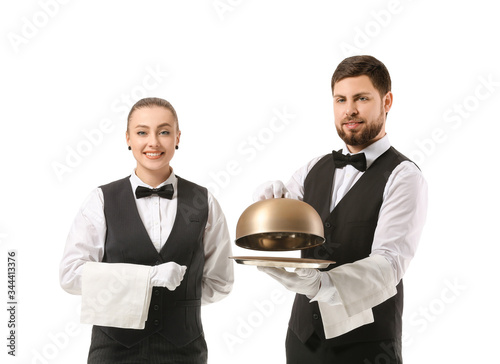 Male and female waiters on ...