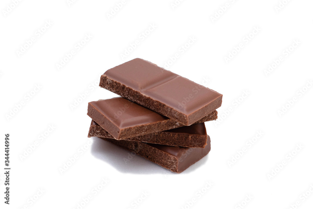 Pieces of chocolate on a white background, isolate. Broken chocolate bar Pieces of chocolate on a white background, isolate. Broken chocolate bar