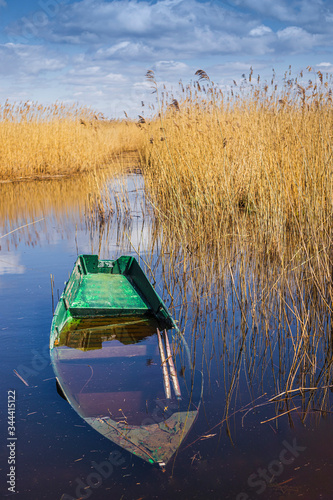 at the edge of the canal stands the boat in the water