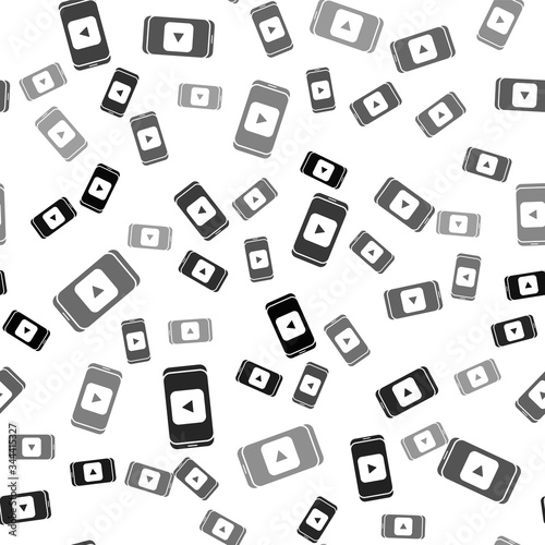 Black Online play video icon isolated seamless pattern on white background. Smartphone and film strip with play sign. Vector Illustration
