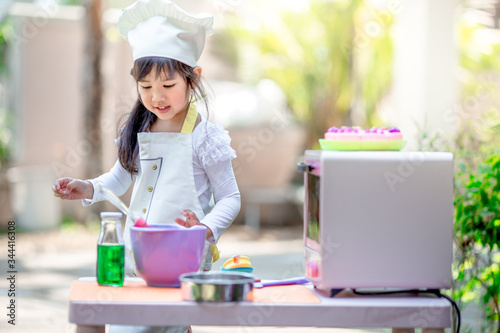 close-up of the baby's background view, dress-up fashion style, love for childhood, practice playing, have fun with cooking, modeling during the summer school holidays