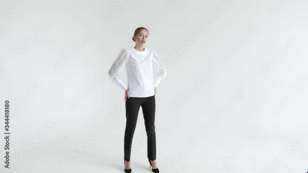 Sexy girl in short shirt on white background posing and smiling, glamorous girl,fashion model Sexy girl in short shirt on white background posing and smiling, glamorous girl,fashion model