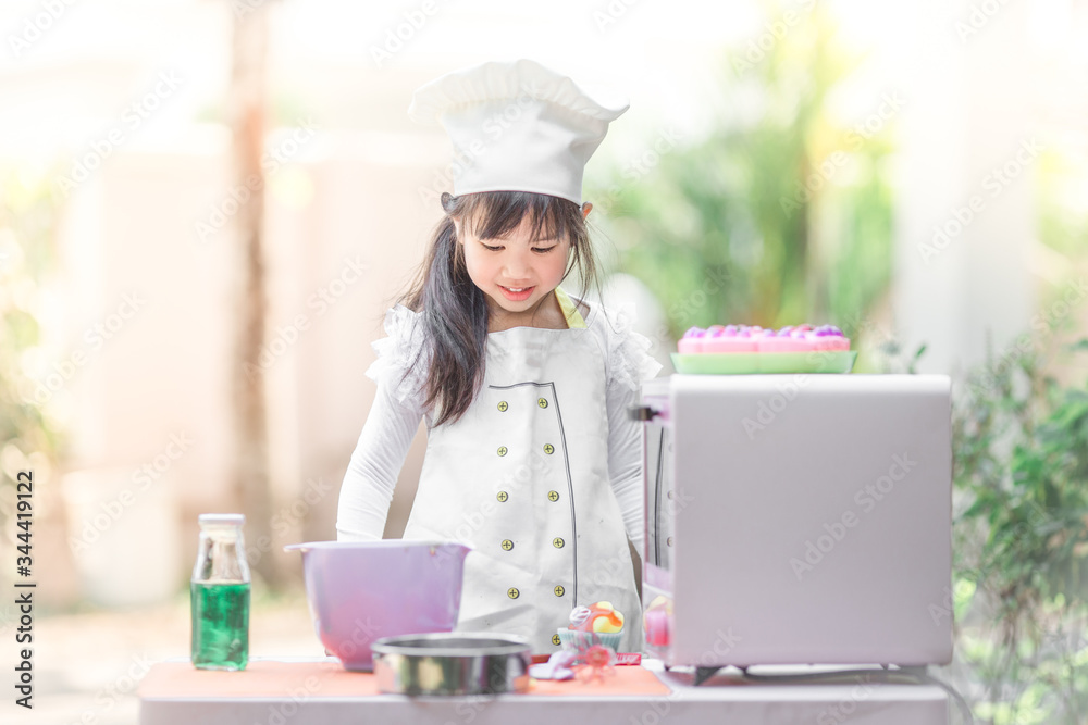 Close up background view Of cute young girls cooking desserts, with an oven and flour, cooking business concepts,learning models and marketing plans Close up background view Of cute young girls cooking desserts, with an oven and flour, cooking business concepts,learning models and marketing plans