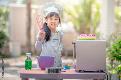 Close up background view Of cute young girls cooking desserts, with an oven and flour, cooking business concepts,learning models and marketing plans