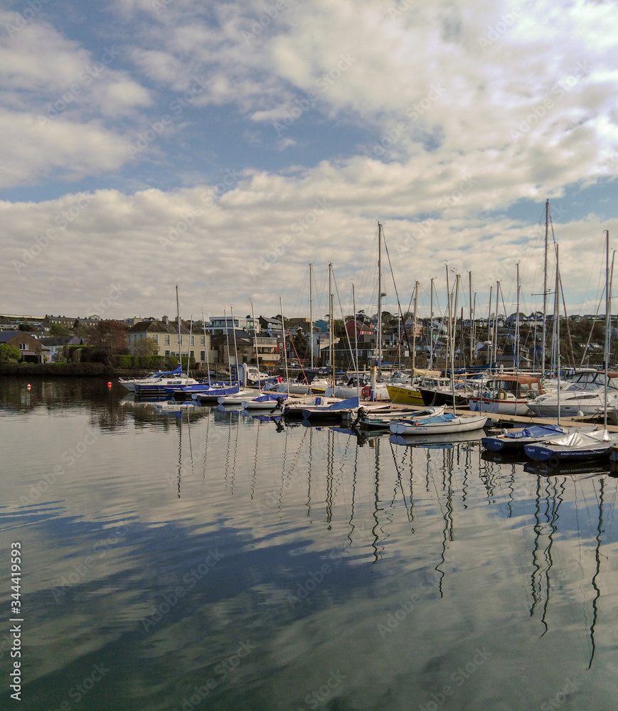 yacht boats in marina with sky reflections