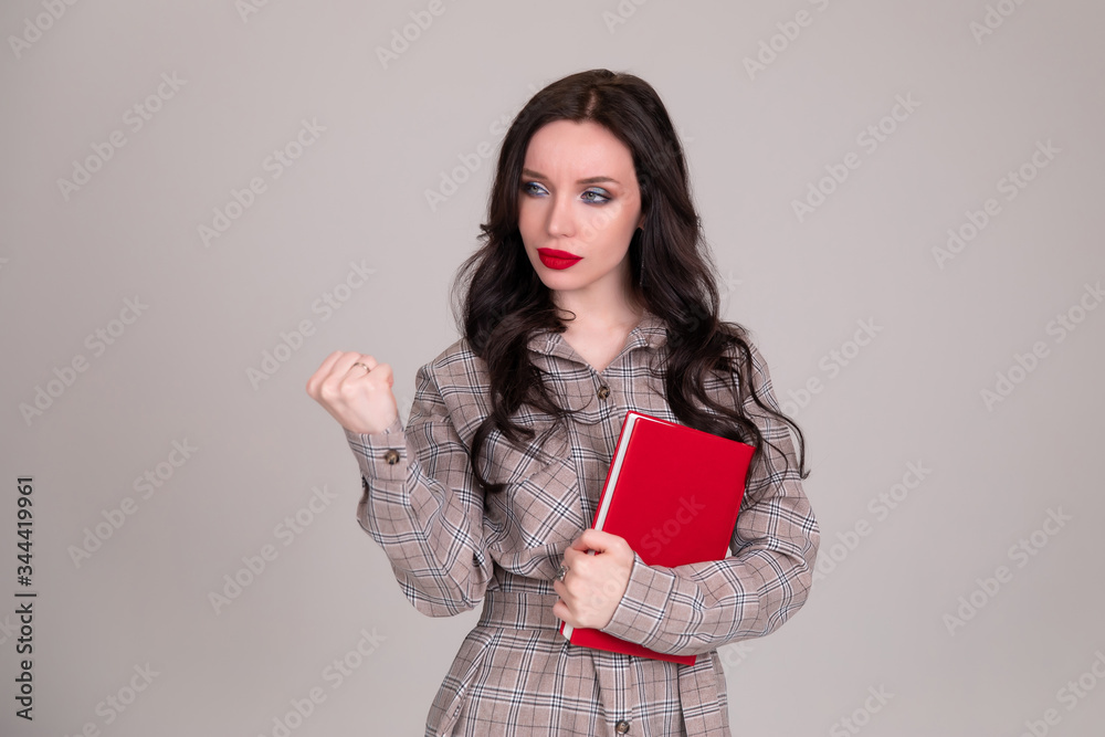 girl on white background shows his fist. Female force. Feminism