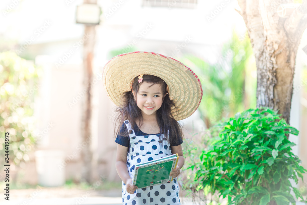 Close-up background view of a cute girl who is watering plants or growing vegetables for health,a crop cultivation program and business expansion