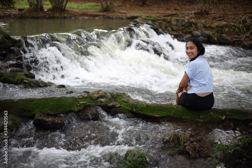 Woman and Nam Tum waterfall in Chanthaburi at thailand 