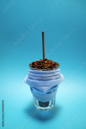 Pandemic concept background. Coronavirus idea. Plastic free. Glass with coffee beans. 