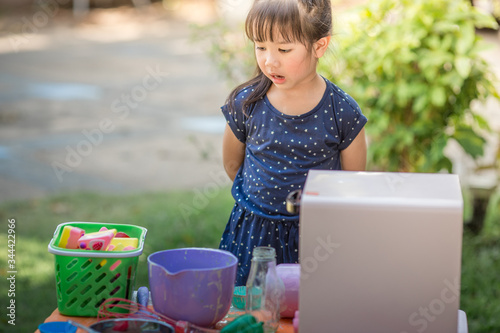 A close-up of the baby's background view, dress-up fashion style, love for childhood, practice playing, have fun with cooking, modeling during the summer school holidays.