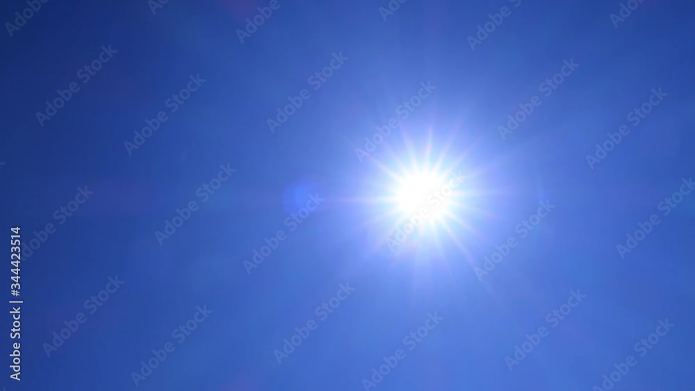 Natural bright sun light ray, sunbeams & flares shining on sunny clear blue sky background in tropical summer or spring midday sunlight at daylight sunshine day, Solar energy power concept TimeLapse Natural bright sun light ray, sunbeams & flares shining on sunny clear blue sky background in tropical summer or spring midday sunlight at daylight sunshine day, Solar energy power concept TimeLapse