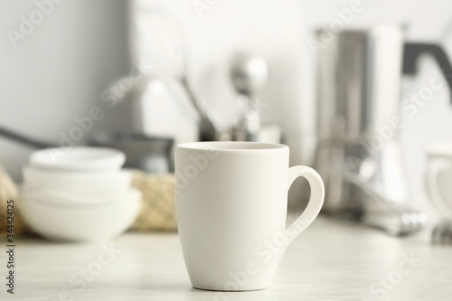 Blank cup on kitchen table