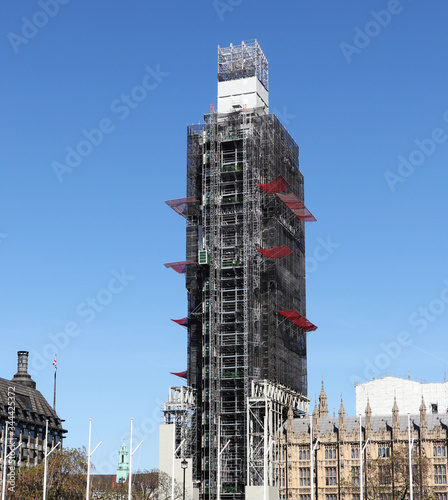 Dominant of London under construction. Tower, with probably the most famous clock, part of Palace of Westminster is in a long-term reconstruction. On Big Ben works many workers photo