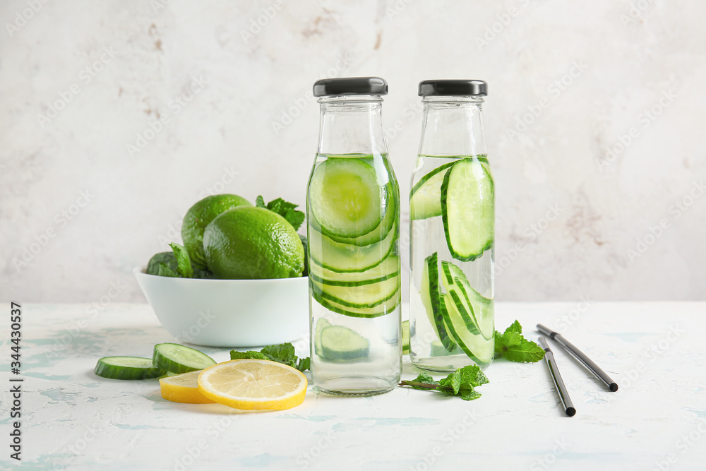 Bottles of cucumber infused water on table