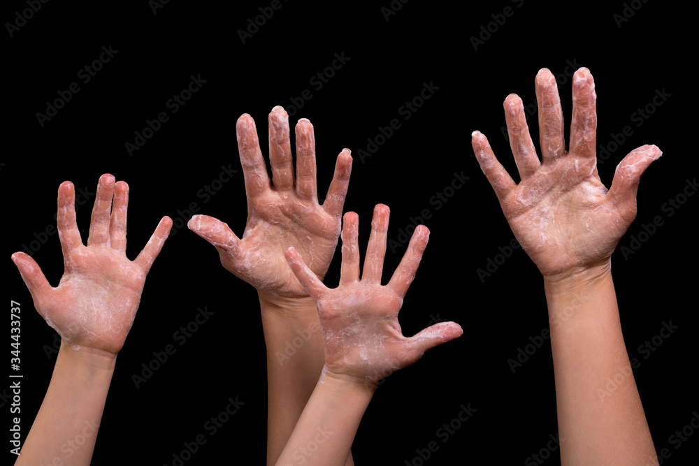 Hands in soap suds on a black background. Hands in soap suds on a black background.