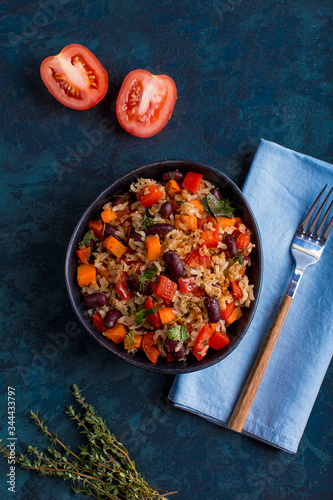 brown rice with vegetables on a blue background