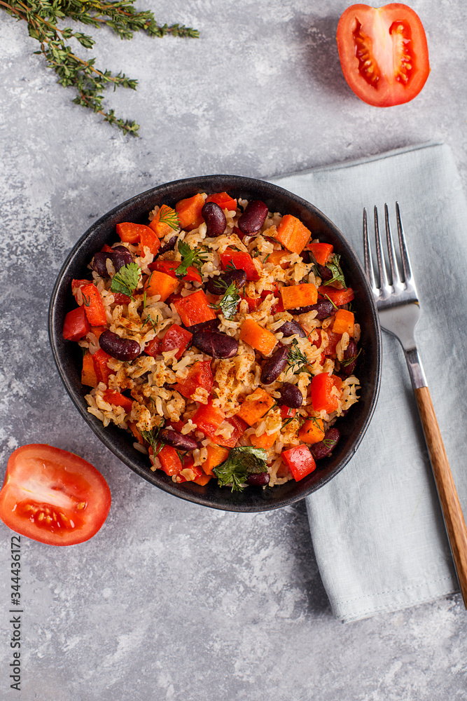 brown rice with vegetables on a grey background brown rice with vegetables on a grey background