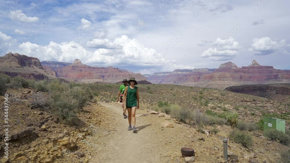 A couple walking inside the Colorado Canyon, Arizona. United States A couple walking inside the Colorado Canyon, Arizona. United States