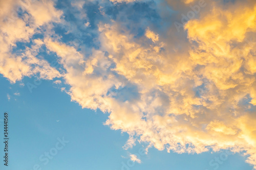 Beautiful gold color clouds on blue sky with crescent moon