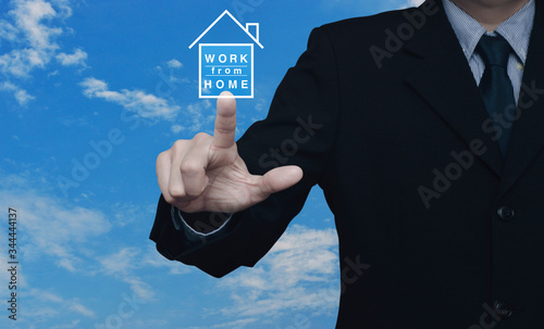 Businessman pressing work from home flat icon over blue sky with white clouds, Business social distancing concept