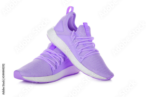 Pair of pink sport shoes on white background
