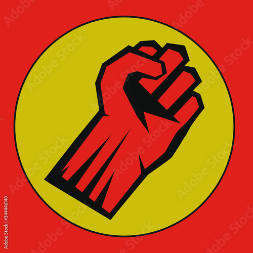 hand clenched into a fist on a yellow background. symbol of the struggle for their rights