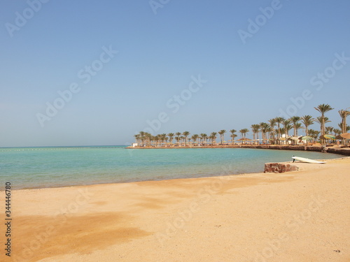 Sand spit with palm trees by the sea © Valeriy
