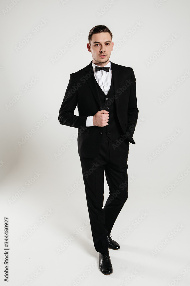 Stylish man posing in elegant black suit Stylish man posing in elegant black suit