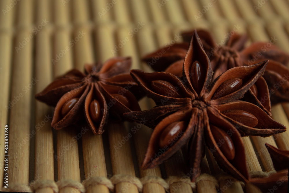 spice star anise in good quality on a bamboo mat with free space for inscription and description spice star anise in good quality on a bamboo mat with free space for inscription and description