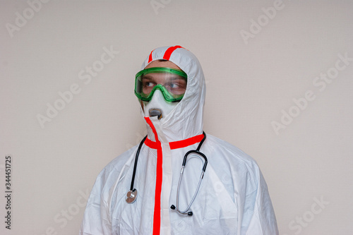 medical officer in protective suit looks away