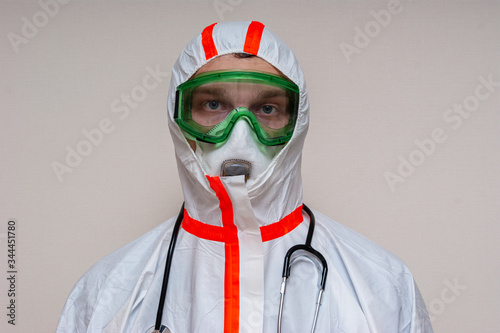 medical officer in protective suit looks forward