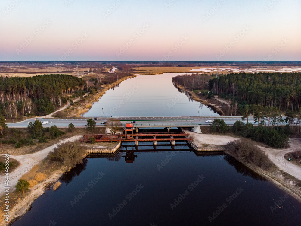 Late evening view of old bridge and new bridge over small river.