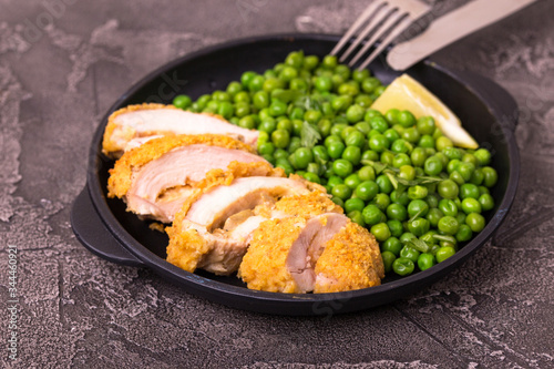 Chicken grilled fillet filled with julienne, lemon and steamed green pea. Healthy food, ketogenic diet. Keto/Paleo