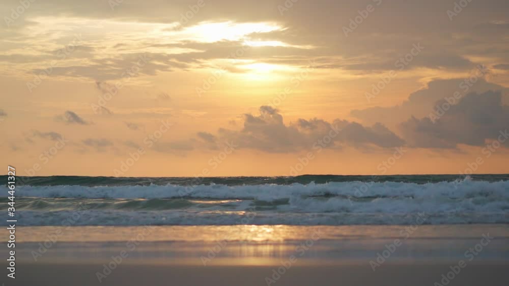 Sea waves on sunset. Yellow sun over sea. Sunlight reflect on water surface Sea waves on sunset. Yellow sun over sea. Sunlight reflect on water surface