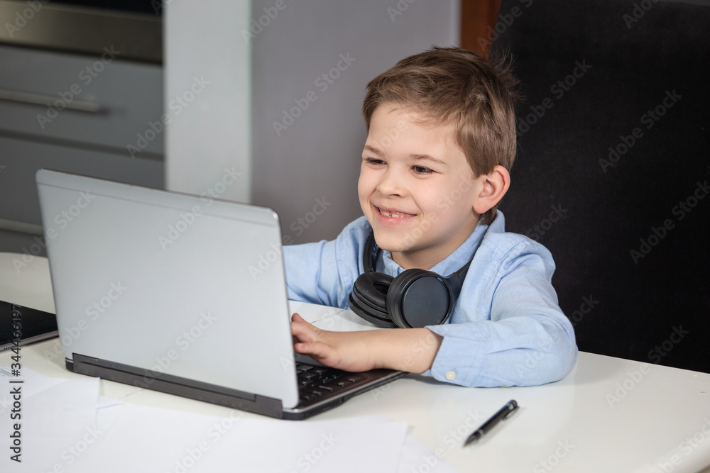 e-learning from home - lovely young boy working with his computer smiling e-learning from home - lovely young boy working with his computer smiling
