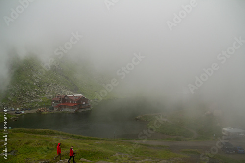 Chalet and Glacier Lake in Sibiu County in fog with reflection