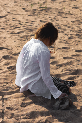 
Girl doomed sill on the beach