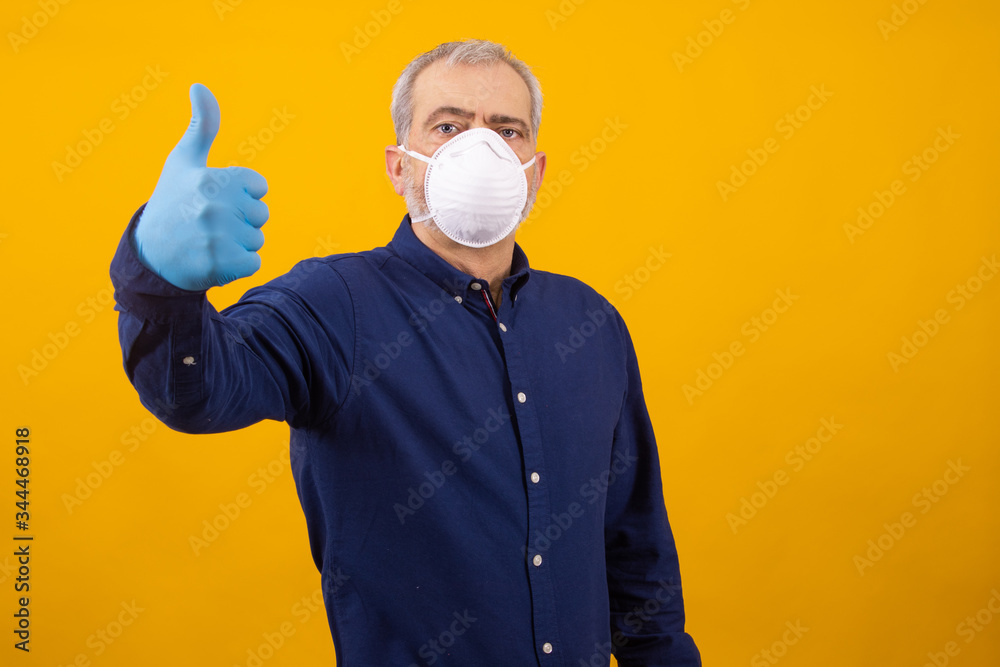 adult or senior man with mask and gloves isolated on background adult or senior man with mask and gloves isolated on background