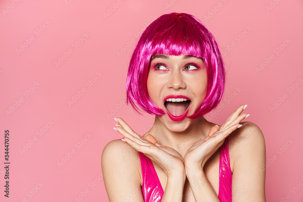 Image of excited beautiful woman in wig laughing and looking aside