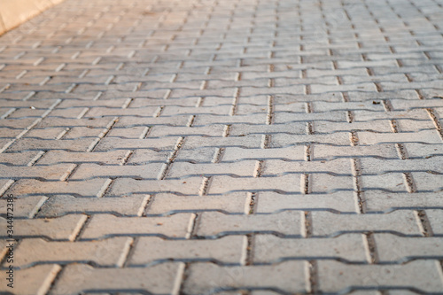 Perspective View Monotone Gray Brick Stone Pavement on The Ground for Street Road. Sidewalk, Driveway, Pavers, Pavement in Vintage Design Ground Flooring Square Pattern Texture Background for mock up