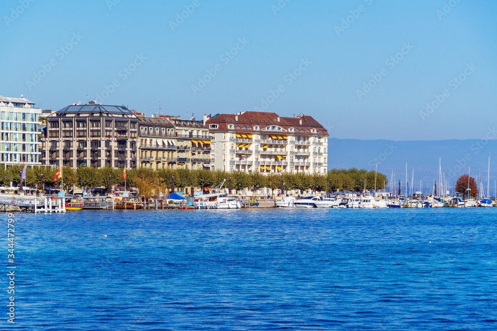 Main promenade on Lake Geneva with retro homes with watch manufacturers advertising, Geneva