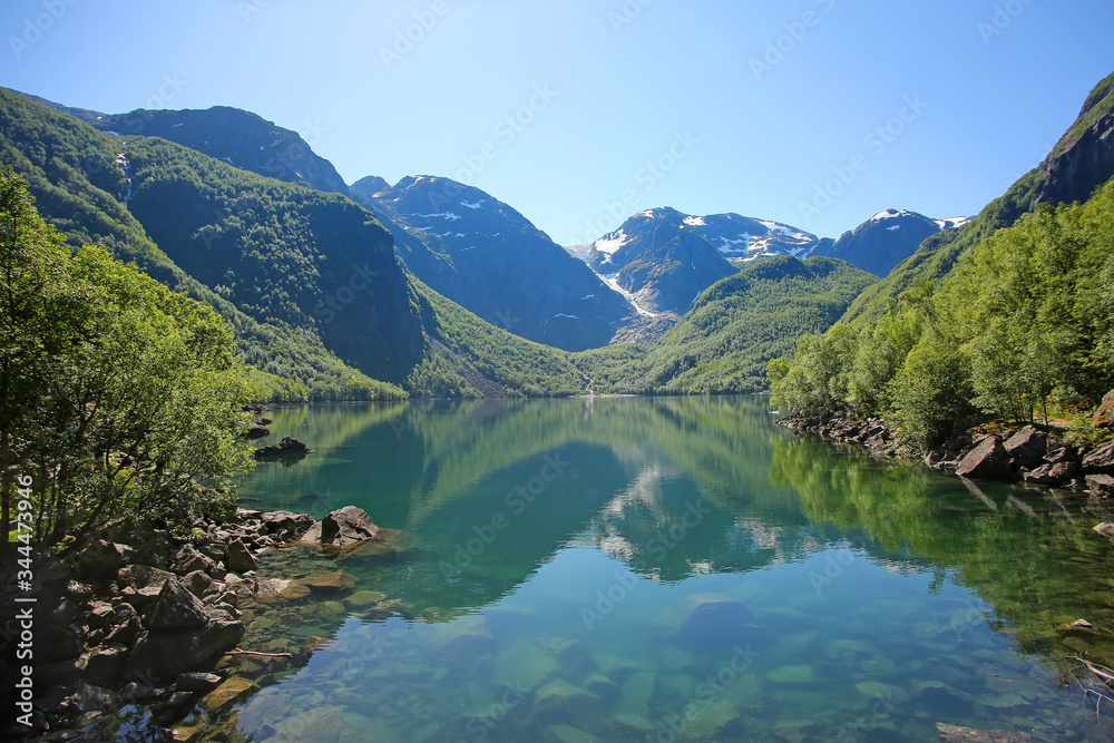 Bondhus Lake with beautiful scenery & reflections in the water. The lake is reached along the mountain hike, near Rosendal, Folgefonna National Park, Norway. Bondhus Lake with beautiful scenery & reflections in the water. The lake is reached along the mountain hike, near Rosendal, Folgefonna National Park, Norway.