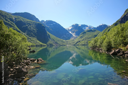 Bondhus Lake with beautiful scenery & reflections in the water. The lake is reached along the mountain hike, near Rosendal, Folgefonna National Park, Norway.