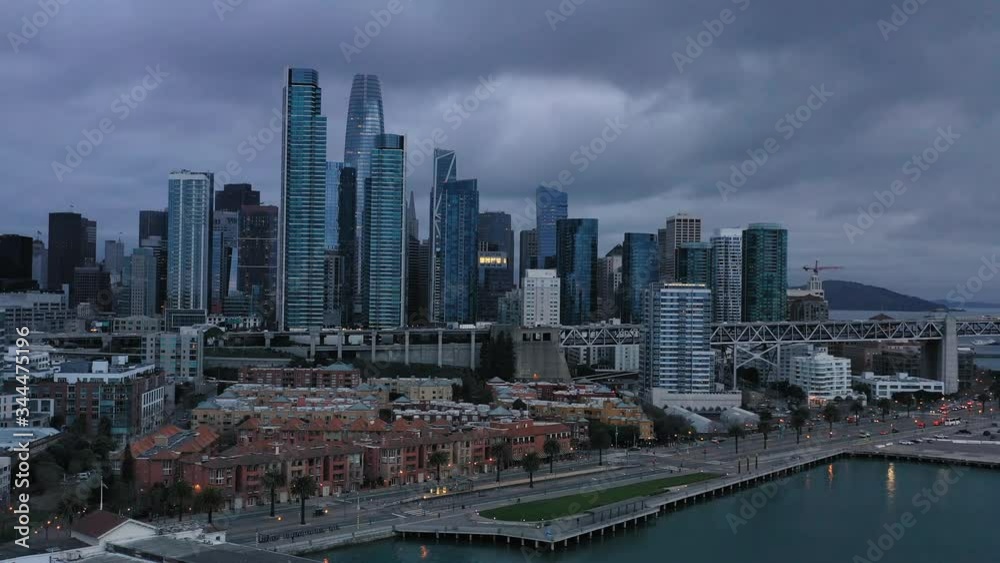 aerial shot of cityscape of San Francisco with Oakland Bay Bridge, cars and skyscrapers. Dark moody weather aerial shot of cityscape of San Francisco with Oakland Bay Bridge, cars and skyscrapers. Dark moody weather
