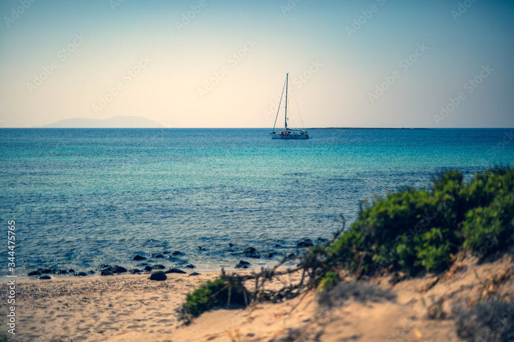 Sailing boat at distant remote island paradise with exotical vivid colors. Sailing boat at distant remote island paradise with exotical vivid colors.