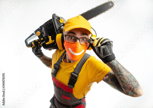 a guy in protective coveralls with a chainsaw on a white background