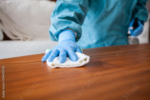 テーブルのウイルス除菌作業をする清掃スタッフ photo