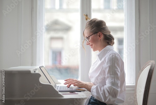 
woman works at the computer from home photo