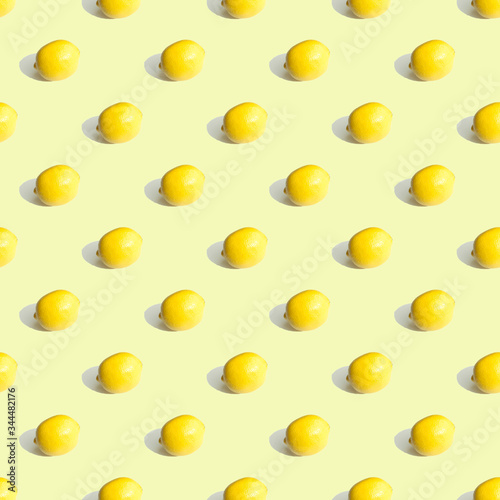 Seamless geometric pattern, whole lemon on a light yellow background. Pattern.